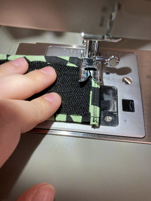 Velcro being sewn into place