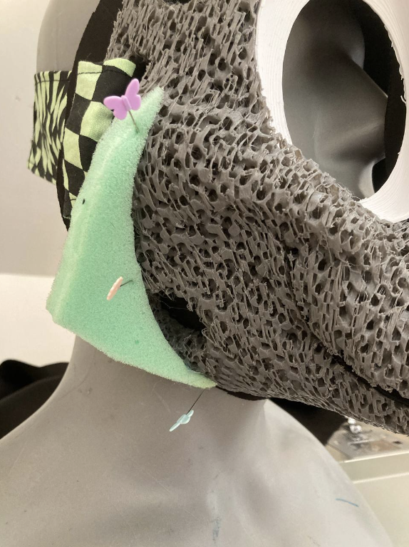 Triangle of foam pinned onto a headbase