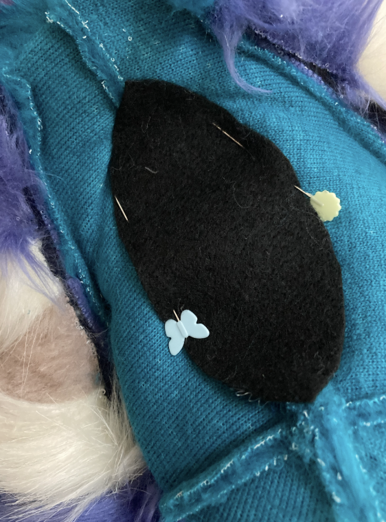 Felt pinned over exposed stuffing