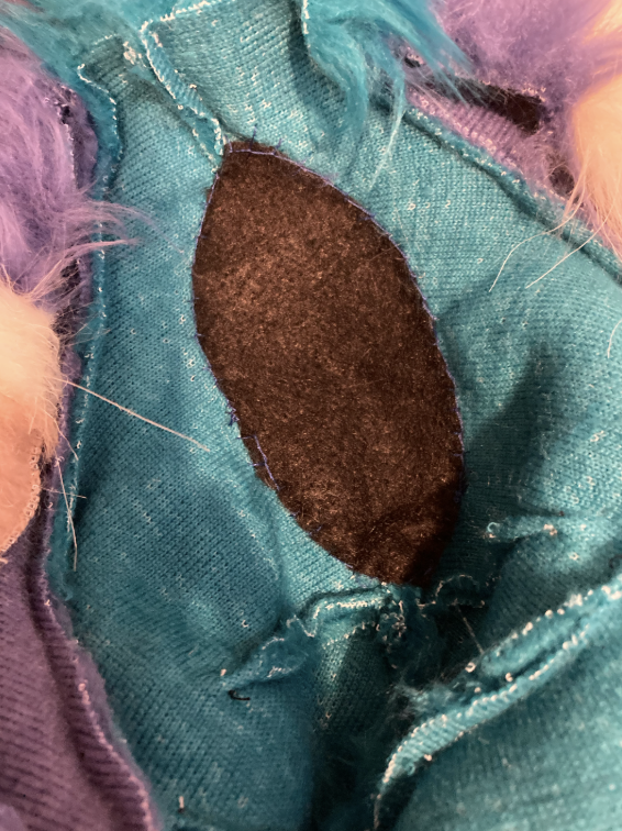 Sewn felt over hair puff opening