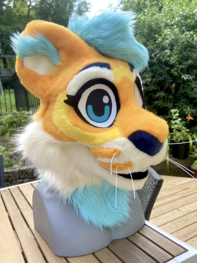 A finished tiger fursuit head with fur muzzle dots