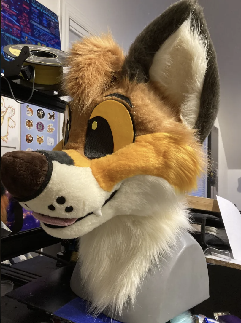 A finished fox fursuit head with solid felt muzzle dots