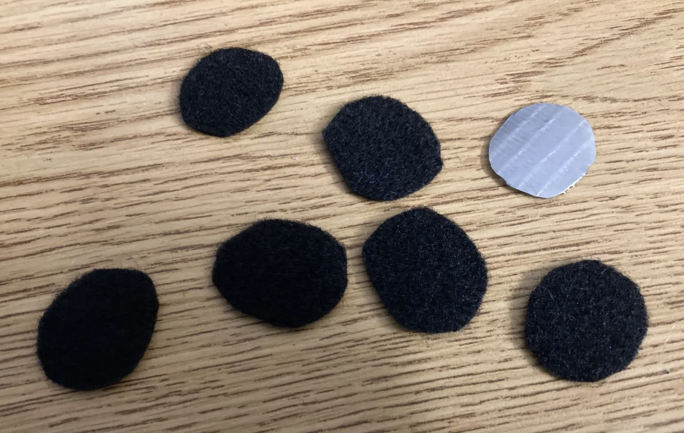 Six felt muzzle dots and a template made of duct tape