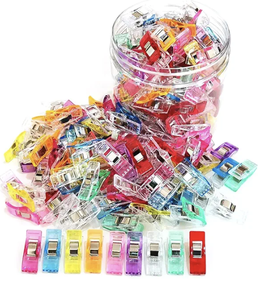 A container of translucent plastic clips in a variety of colors