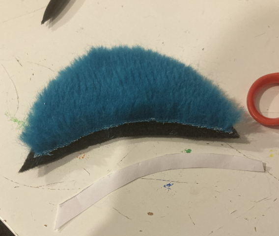 Furred eyelid, but with the line from the paper template separated from the template and resting next to the eyelid